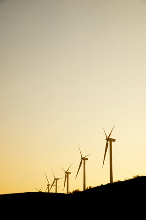 Wind turbine generators for sustainable electrical energy production at sunriseの写真素材