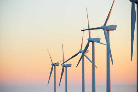 Wind turbine generators for sustainable electrical energy production at sunriseの写真素材
