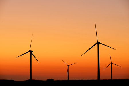 Wind turbine generators for sustainable electrical energy production at sunriseの写真素材