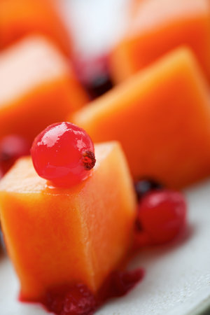Papaya pieces and berries in a dishの写真素材