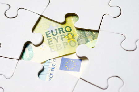 Euro banknotes on a white puzzleの写真素材