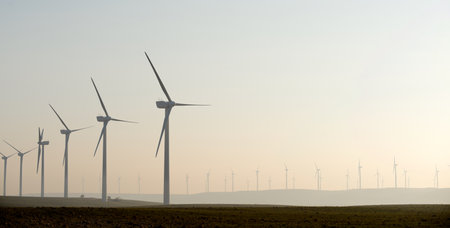 Wind turbine generators for sustainable electrical energy production at sunriseの写真素材