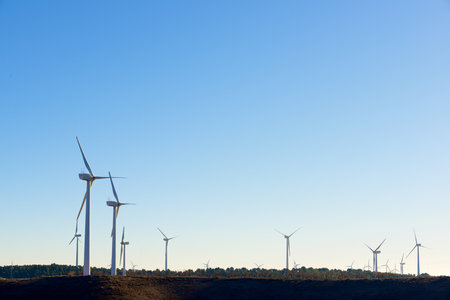 Silhouettes of windmills for the production of electric green energy in Spain.の写真素材