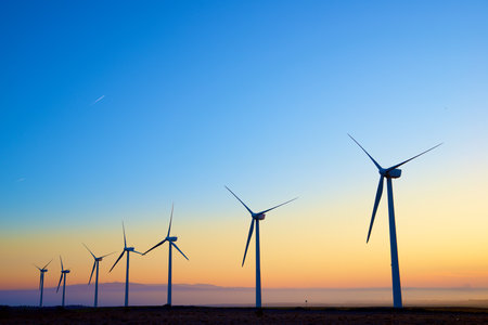 Wind turbine generators for sustainable electrical energy production at sunriseの写真素材