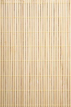 Closeup of a tablecloth made of stitched bamboo rods.の写真素材