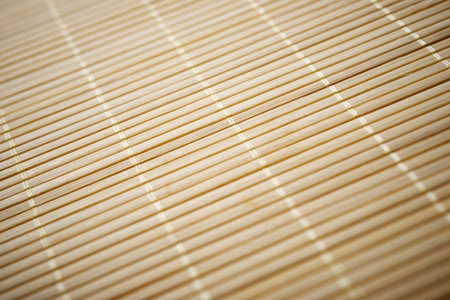 Closeup of a tablecloth made of stitched bamboo rods.の写真素材