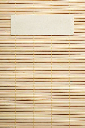 Close-up of a tablecloth made of bamboo rods and label for writing textの写真素材