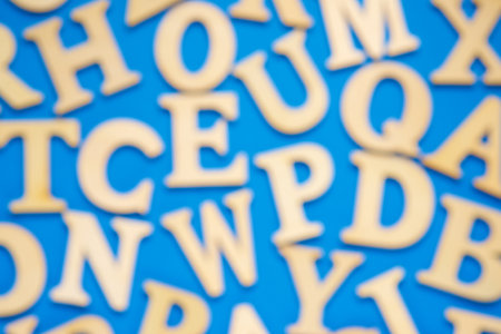 Wooden letters to play on a blue tableの写真素材