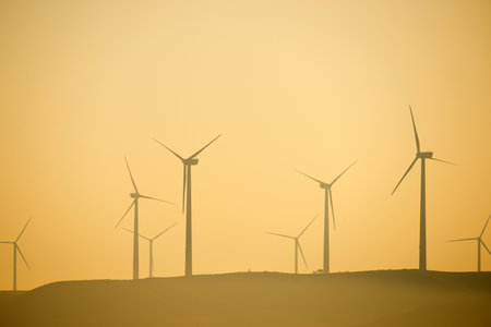 Wind turbine generators for sustainable electrical energy production at sunriseの写真素材