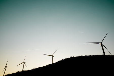 Wind turbine generators for sustainable electrical energy production at sunriseの写真素材