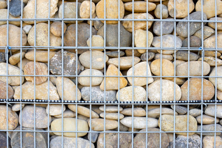 Wall formed by pebbles and metal mesh for ground support.の写真素材