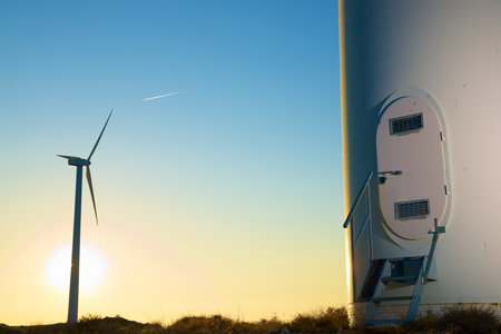 Entrance to wind turbine generator for sustainable electricity production at sunsetの写真素材