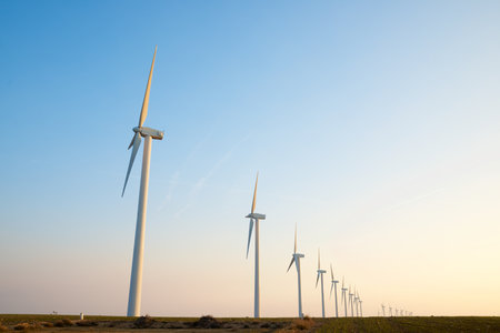 Wind turbine generators for sustainable electrical energy production at sunriseの写真素材