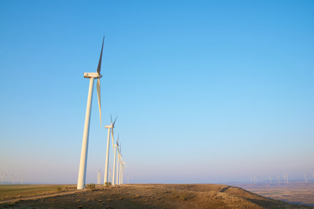 Wind turbine generators for sustainable electrical energy production at sunriseの写真素材