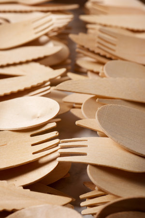 Pieces of disposable wooden cutlery on a tableの写真素材