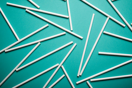 Disposable drinking straws made of cardboard on a green tableの写真素材