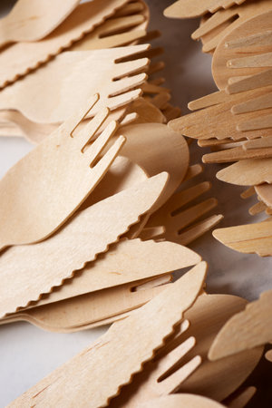 Pieces of disposable wooden cutlery on a tableの写真素材