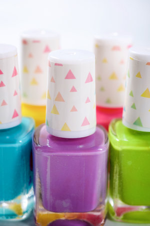 Close-up of five bottles of nail polish for girlsの写真素材