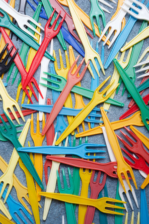 Small disposable plastic forks on a tableの写真素材
