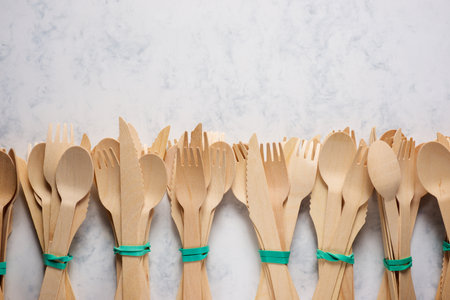 Pieces of disposable wooden cutlery on a tableの写真素材