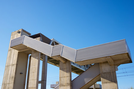 Concrete footbridge for the passage of people over a railroad track in Spainの写真素材