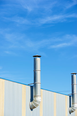 Two chimneys on the facade of a factory in Spainの写真素材