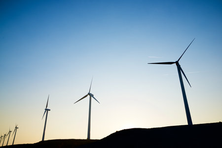 Wind turbine generators for sustainable electrical energy production at sunriseの写真素材