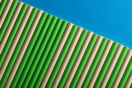 Close-up of disposable drinking straws made of cardboard on a blue tableの写真素材