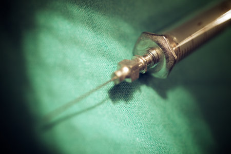 Retro syringe on a green hospital fabricの写真素材