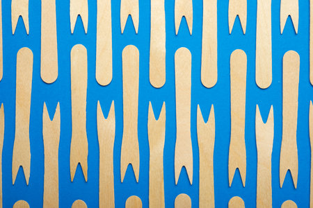 Pieces of disposable wooden forks on a blue table