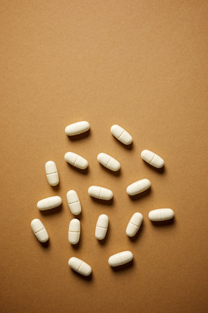 Brown medicine tablets on a brown tableの写真素材