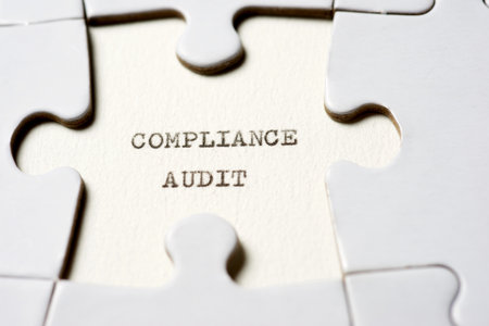 Compliance audit text written with a typewriter in a white puzzleの写真素材