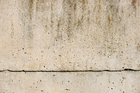 Texture of an old and weathered reinforced concrete wall.の写真素材