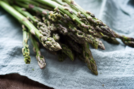 Group of wild asparagus on a blue tea towel.の写真素材