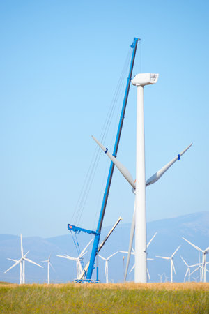 Construction of a windmill, with a huge crane, for sustainable electrical energy productionの写真素材
