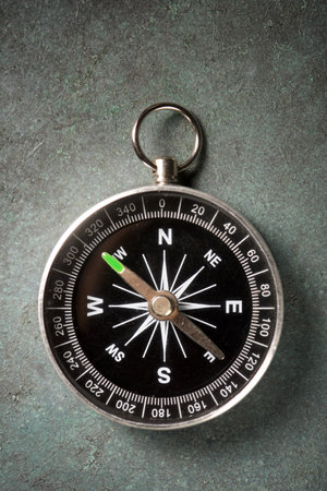 Close up of a compass on a green stone tableの写真素材
