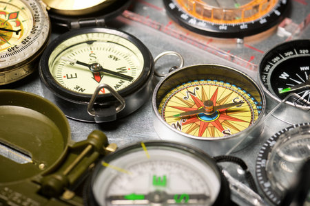 Close up of a group of compasses on a metal surfaceの写真素材