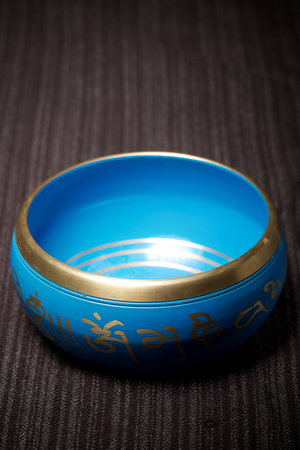 Close-up of a Tibetan bowl on a typical blanketの写真素材