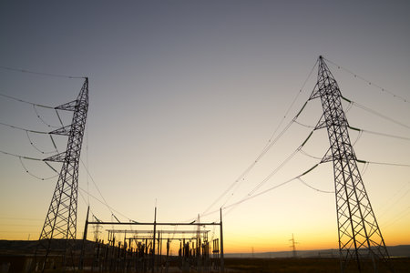 Electrical substation for energy distribution and orange skyの写真素材