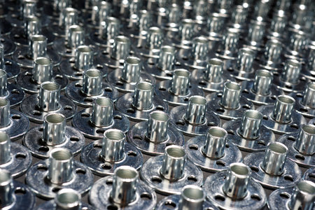 Close up of a group of tee nuts for fixing metal screws to wooden partsの写真素材