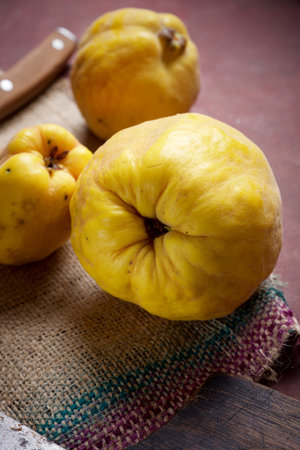 Close up of a group of fruit quinces on a kitchen tableの写真素材