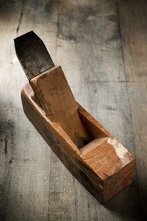 Close up of an old disused carpenter's plane on a work bench.
