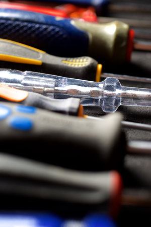 Close up of a group of various screwdrivers on a work bench