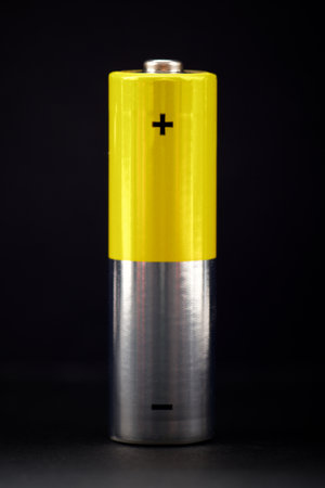 Close up of a yellow battery on a black backgroundの写真素材