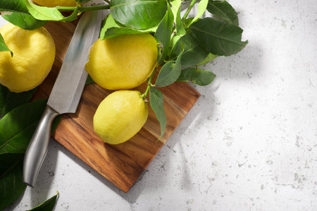Close up of some lemons on a chopping board on a kitchen countertopの写真素材