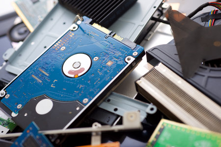 Close up of stacked components of an old laptop on a table.