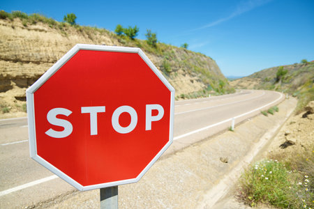 Close-up of stop sign and clear blue sky