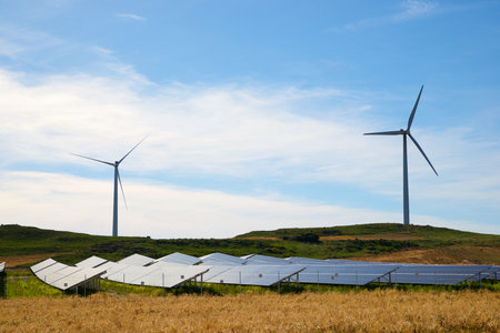 Many photovoltaic panels for sustainable electrical energy production and windmills in Zaragoza...
