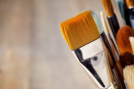 Close up of a group of artistic brushes on a wooden tableの写真素材