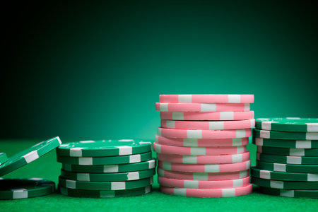 Close-up of a group of casino chips on a green matの写真素材